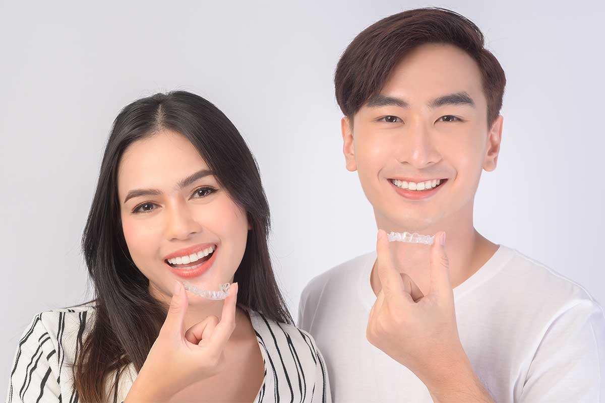 Beautiful couple smiling with Invisalign