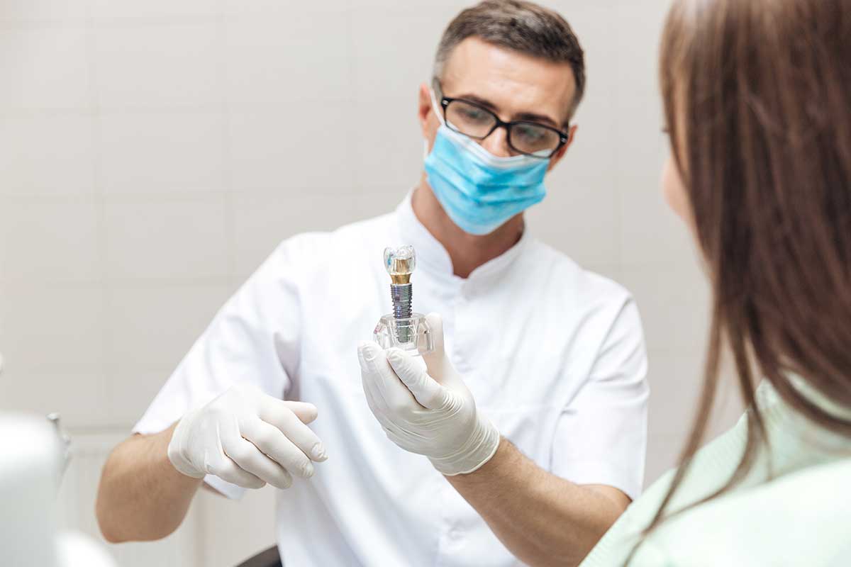 Dentist explain about dental implants for his patient