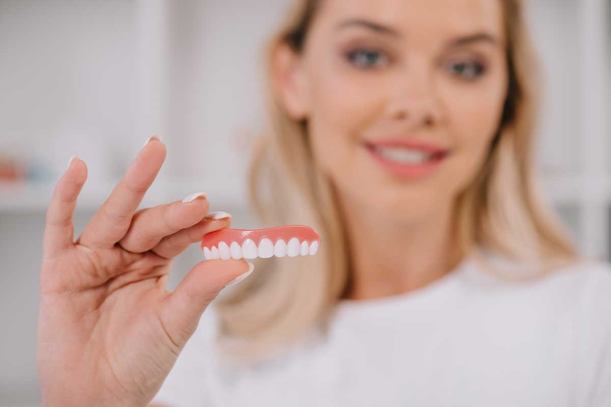 Selective focus of teeth cover with smiling woman