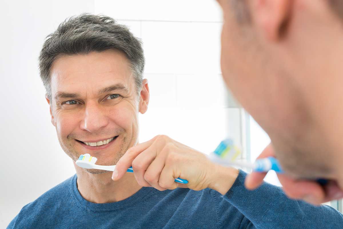 Man holding a toothbrush on his hand