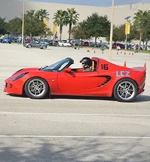 Dr. Russo driving a red sports car in Orlando.