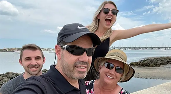 Dr. Russo and team smiling together at a beach in Orlando, Florida.