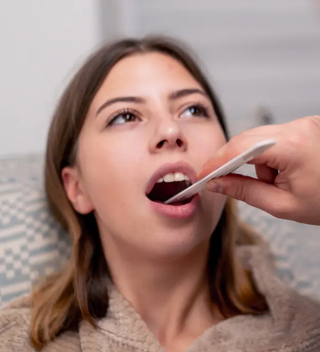 Patient receiving oral cancer screening examination by dentist in Orlando.