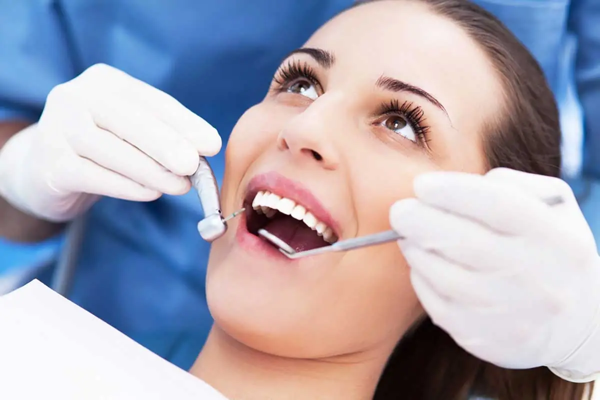 Woman receiving dental examination and treatment from dentist in Orlando.