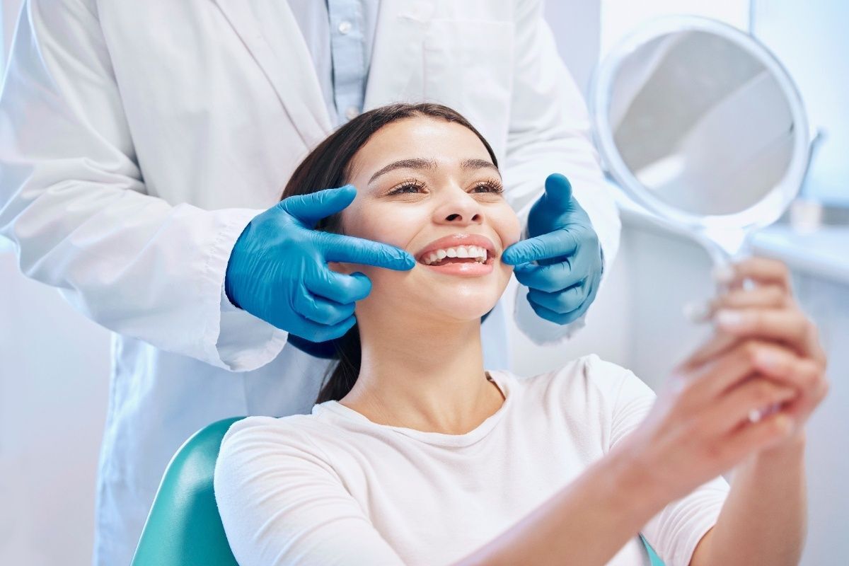 Dentist examining patient's smile during cosmetic dental consultation in Orlando.