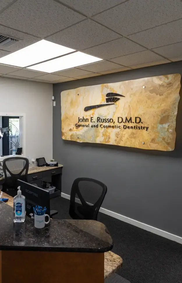 John E. Russo, D.M.D. General and Cosmetic Dentistry logo.