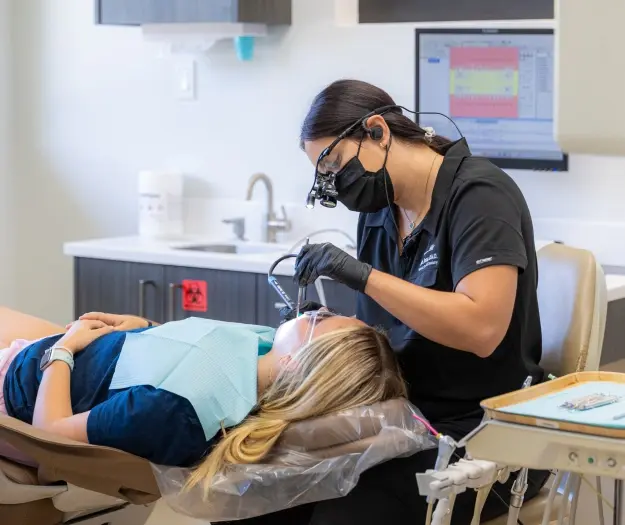 Dentist performing emergency dental treatment on patient in Orlando dental office.