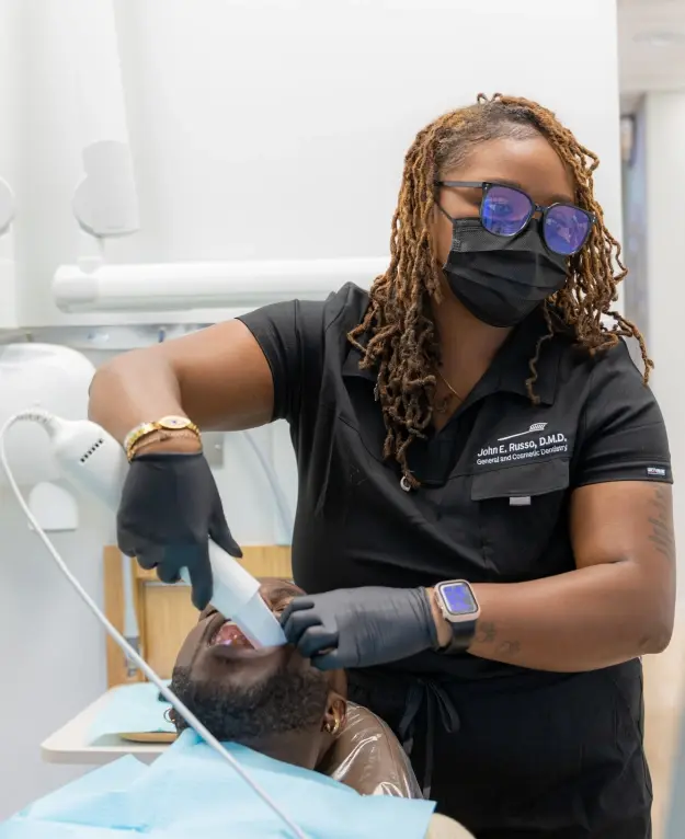 Dentist examining patient's teeth in Orlando general dentistry practice.