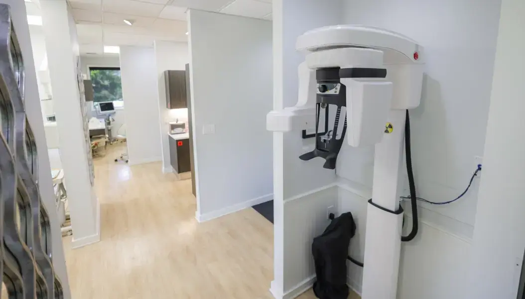 Modern dental office hallway featuring advanced CBCT imaging equipment in Orlando.