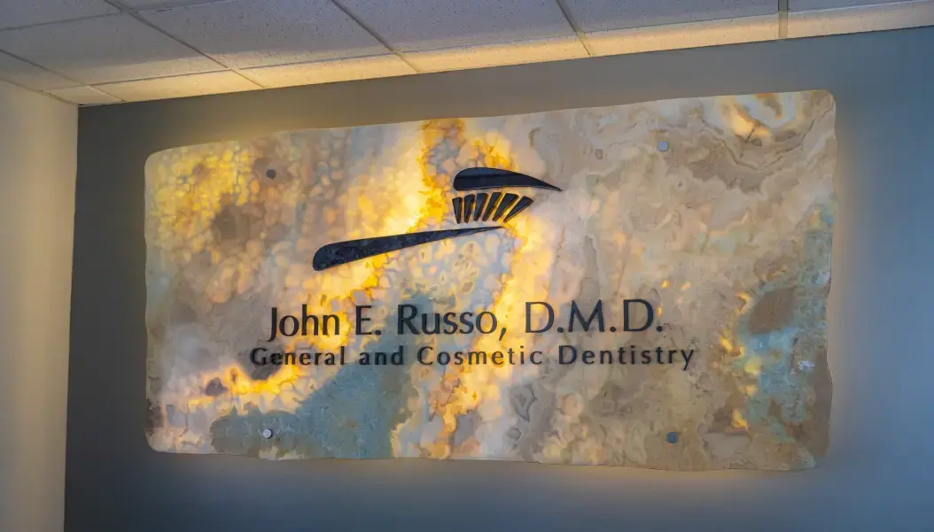 John E. Russo, D.M.D. logo.